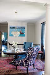 Dining Room, Table, Chair, Ceiling Lighting, Medium Hardwood Floor, Rug Floor, and Pendant Lighting Welcoming anyone who enters the house is a Jonathan Adler print of photographer Slim Aaron’s “Sea Drive”. It’s a 1960’s retro-modern photograph of a family taking a joy ride across the water in an Amphicar.   Photo 8 of 11 in Classically Modern by Big Sky Design