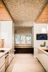 Kitchen, Accent Lighting, Engineered Quartz Counter, Ceramic Tile Floor, Wall Oven, Range, Dishwasher, Undermount Sink, Refrigerator, White Cabinet, and Pendant Lighting  Photo 7 of 28 in Bound Together by Big Sky Design