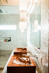 Bath Room, Accent Lighting, Vessel Sink, Concrete Counter, Ceramic Tile Floor, Enclosed Shower, Wall Lighting, Pendant Lighting, Full Shower, and Glass Tile Wall Custom sapele wood sinks to match the custom tub.  Photo 19 of 28 in Bound Together by Big Sky Design