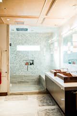 Bath Room, Vessel Sink, Concrete Counter, Wall Lighting, Enclosed Shower, Ceramic Tile Floor, Full Shower, Pendant Lighting, and Glass Tile Wall  Photo 20 of 28 in Bound Together by Big Sky Design