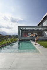 Outdoor, Back Yard, Swimming Pools, Tubs, Shower, Vertical Fences, Wall, Grass, Concrete Patio, Porch, Deck, Infinity Pools, Tubs, Shower, and Small Patio, Porch, Deck  Photo 6 of 15 in INTERLACE HOUSE by TEC Taller EC