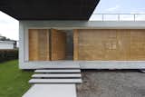 Outdoor, Grass, Front Yard, and Wood Fences, Wall  Photo 10 of 15 in INTERLACE HOUSE by TEC Taller EC