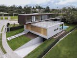 Exterior, Concrete Siding Material, Metal Roof Material, Wood Siding Material, Flat RoofLine, Metal Siding Material, and House Building Type  Photo 14 of 15 in INTERLACE HOUSE by TEC Taller EC