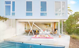 First floor glass facade opens completely to connect indoor and outdoor spaces