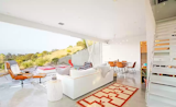 Main living space is designed with minimal details including the white steel stair