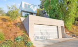 The garage is enclosed with a full-width translucent glass garage door 