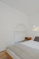 Bedroom, Bed, Storage, Night Stands, Cork Floor, and Table Lighting  Photo 13 of 23 in Rua Maria Loft by KEMA studio