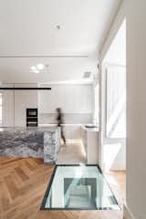 Kitchen, White Cabinet, Ceiling Lighting, Medium Hardwood Floor, Wall Oven, and Granite Counter  Photo 6 of 34 in VILA FERREIRA by KEMA studio