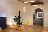 Rear end of main multi-mode room with door to bathroom and arch to kitchen beyond