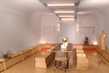Main multi-mode room looking toward entry set for large dinner party with custom tables and benches