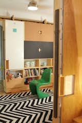 Moving storage unit in playroom with usable surfaces on doors and work table (up)