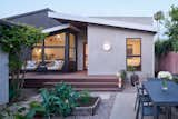 View of the addition from the garden.  Richlite siding made of recycled paper, DassoXTR bamboo decking and soffits, and Louis Poulsen LED lighting are just some of the sustainable features of the home.