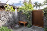 Along with infinity-edge pool and ample seating areas, the backyard boasts outdoor lava rock showers and a tub. The ideal ambiance for entertaining is available at the push of a button that lights tiki torches, activates rooftop misters, and attractive fountain features, as well as turns on the sunset fire pit.