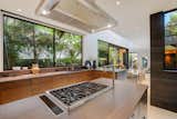 Cook up a delectable meal while taking inspiration from the lush scenery in the chef's kitchen that features an oversized island with a high-end Wolf built-in cooktop, plenty of built-in storage, recessed lighting, and the most charming custom leather built-in breakfast nook.

Retreat upstairs to your secluded primary suite highlighting a tranquil zen-like ambiance and sliding glass doors that lead to a chic ensuite spa bathroom with handsome wood paneling and a sunken tub.