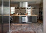 Kitchen, Wood Counter, Metal Cabinet, Laminate Cabinet, Cooktops, and Dishwasher  Photo 9 of 16 in Country House by zanon architetti associati