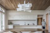 Kitchen, White Cabinet, Pendant Lighting, Light Hardwood Floor, Range, and Range Hood  Photo 9 of 9 in Windy Gap Residence by Altura Architects