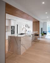 Kitchen, Quartzite Counter, White Cabinet, Light Hardwood Floor, Ceiling Lighting, Subway Tile Backsplashe, Recessed Lighting, Undermount Sink, and Wall Oven  Photo 3 of 14 in Richview Residence by StudioAC
