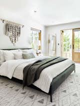 A duvet can be paired with a quilt for extra warmth and a layered look. In this guest bedroom, designer Emily Henderson cast a dark green, velvet, upholstered bed as the central star, pairing it with a lightweight duvet from Target and two cozy quilts.  Photo 1 of 12 in How Much Should You Spend on a Duvet?