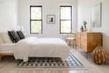 A cream linen duvet cover from Parachute lends a period-appropriate look to this light, bright 1900s rowhouse in Ridgewood, Queens. Keren Richter designed the mudcloth pillows and selected a Muji Ash bed and vintage Paul McCobb dresser to complete the room.  Photo 11 of 12 in How Much Should You Spend on a Duvet?