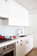 For this apartment overlooking New York City's High Line, the client wanted a clean and minimal aesthetic. Pulltab Design chose Dornbracht’s Tara Ultra to make a statement against Chalk White Heath ceramics backsplash and Statuary countertops.   Photo 4 of 11 in How Much Should You Spend on a Kitchen Faucet?