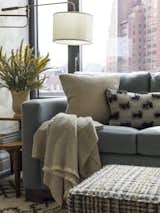 Living, Sofa, Rug, Ottomans, Accent, and Lamps For this family room, Gideon Mendelson chose a high pile, Morrocan-style rug from West Elm that cost $800. The combination of high pile, pattern, and durability means that stains and spills won’t be as easily seen.  Living Lamps Ottomans Sofa Photos from How Much Should You Spend on an Area Rug?