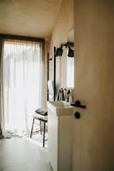 The home has a single bathroom with a tiled shower and small sink. There are some customization options when ordering a Manta North home, including the choice of black or gray light fixtures.