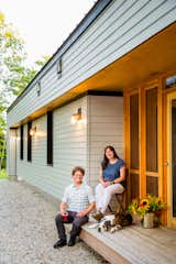 Jenn and Matt Fortin on the porch of their passive house in Denmark, Maine.