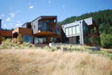 The home reaches out to its landscape with a cantilevered balcony and shifting forms. As a result, adjacent outdoor spaces vary in complexity from covered to open to big to small.