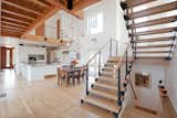Exposed floor joists, open stair risers, and carefully detailed steel connections showcase the home's use of rich materials and the uniqueness of the way it was constructed.