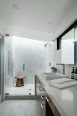 A skylight in the shower creates a wall-wash of natural light. 