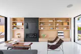 The integrated television, fireplace and built-in casework anchor the minimalist aesthetic. 