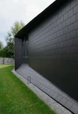 Exterior, Tile Roof Material, Stone Siding Material, Gable RoofLine, House Building Type, Brick Siding Material, and Wood Siding Material  Photo 16 of 17 in BLACK ROCK by MUS ARCHITECTS