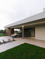 The overhang of House BN provides shelter for the homeowner’s automobile. The contemporary villa’s entrance corridor faces toward the nearby Monte Grappa mountain.

