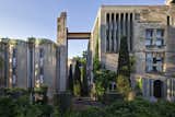The exterior of Ricardo Bofill Taller de Arquitectura's headquarters features rugged concrete and climbing greenery.