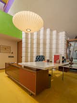 Office, Carpet Floor, Chair, and Desk Dow also incorporated iconic pieces of furniture and decorative objects into his office, like George Nelson's Saucer Lamp, which hangs above his desk.  Photo 15 of 15 in A Midcentury Time Capsule Captures an Architect's Love For Iconic Design