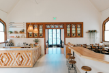 Dining Room, Bar, Table, Stools, Pendant Lighting, Chair, and Light Hardwood Floor Amenities include a workout studio, kitchen area, and a spacious backyard with fruit trees.

  Photo 3 of 17 in 6 Co-Working Clubs Catered to Women That Radiate Good Vibes and Beautiful Designs
