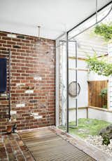 Bath Room, Open Shower, Brick Floor, and Drop In Tub A private garden is accessible by a glass panel.  Photos from An Australian Cottage Gets a Japanese-Inspired Makeover and a New Home Office