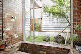 Bath, Drop In, Open, and Brick The shower area and sunken brick tub were constructed using red clay bricks salvaged from demolition sites around Victoria.  Bath Brick Drop In Open Photos from An Australian Cottage Gets a Japanese-Inspired Makeover and a New Home Office