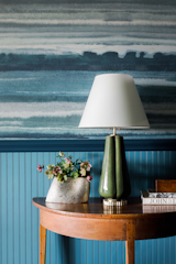 In the foyer, Phillip Jeffries’ tranquil blue Fade Sea Spray wallpaper gives a subtle nod to the nearby Blue Ridge Mountains, which guests have views of from the property.