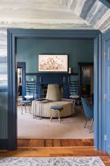 Off the foyer, what was originally the check-in area for guests was turned into a swanky lounge, featuring a round "sociable sofa," upholstered in Kravet Verbier Diamond fabric in Leaf/Teal.