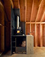 Inside, a Cubic Mini wood stove warms the cozy 8' x 12' space.