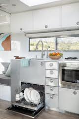 The 2020 model’s kitchen includes all the comforts of home with a dishwasher, pull-out microwave, large refrigerator, and oven and stove combo.