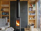 The Iwaki cast-iron wood stove by Invicta keeps the space warm during Poland’s cold winters.&nbsp;