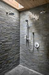 The clay tiles in the master suite’s shower were cut and fired by hand. The natural, textured tiles vary in color, and they were fired with a high-gloss finish, giving the shower the appearance of a shimmering cave.