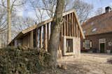 Annemariken and Geert sourced old oak trees from their estate to build a barn that provides space for storage, working, and a car port.