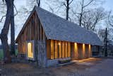 Bark gives the exterior walls a  textured appearance and allows them to blend into the forested surroundings.