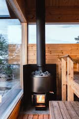 A traditional Finnish wood stove by Kota Luosto heats not just the sauna, but the running water and floors throughout the cabins.