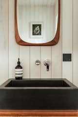 Earthy materials like natural wood tones, limestone and Italian lava stone were used in the bathroom.