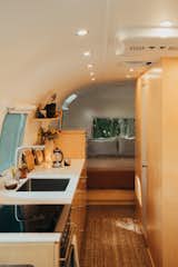 The kitchen features small appliances—including a marine refrigerator, gas burner, and oven.