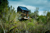 The two-story cabin runs solely off of solar power and rainwater.&nbsp;